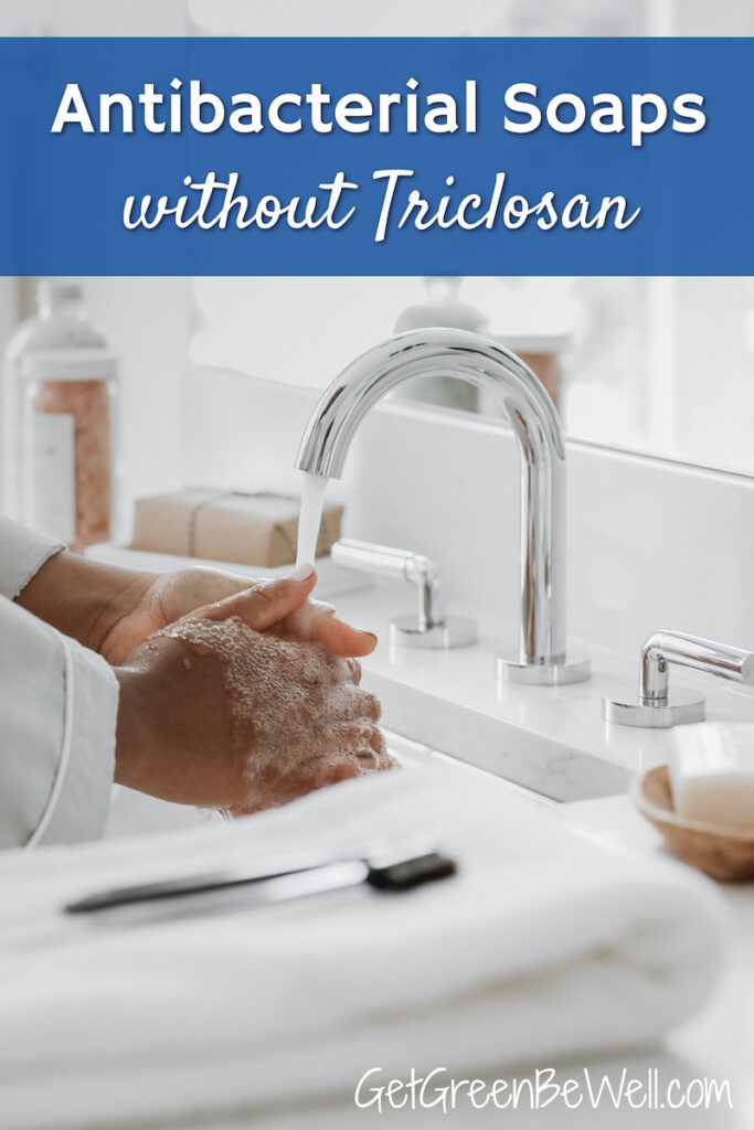 woman washing hands with soap under faucet