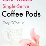 white coffee cup with gold polka dots against white background with pink Lilly flower