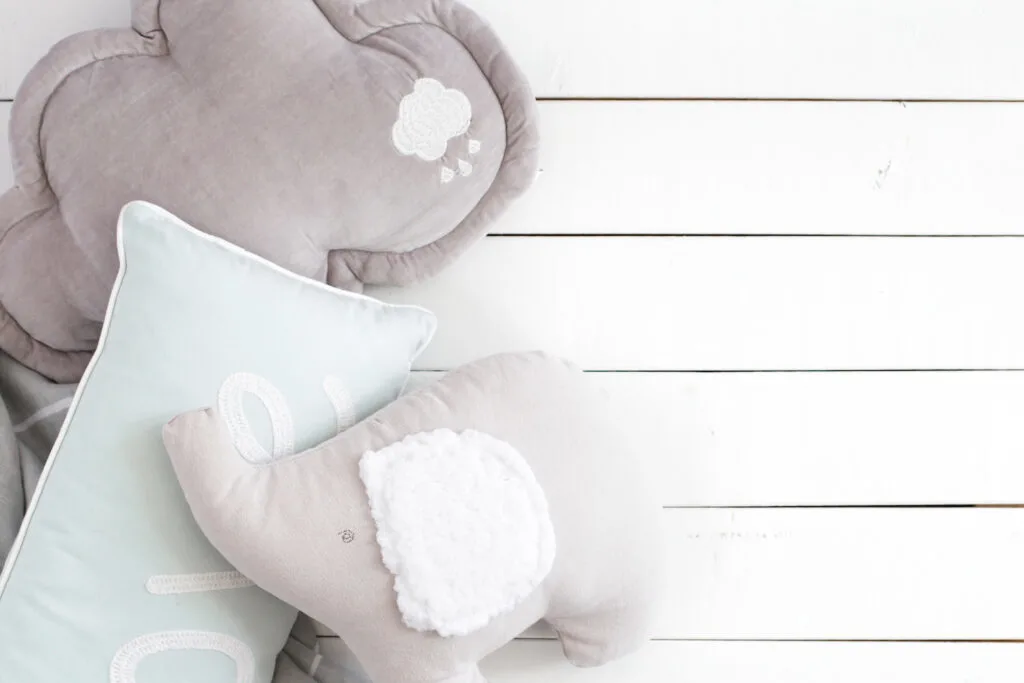 grey elephant stuffed animal for baby against white background
