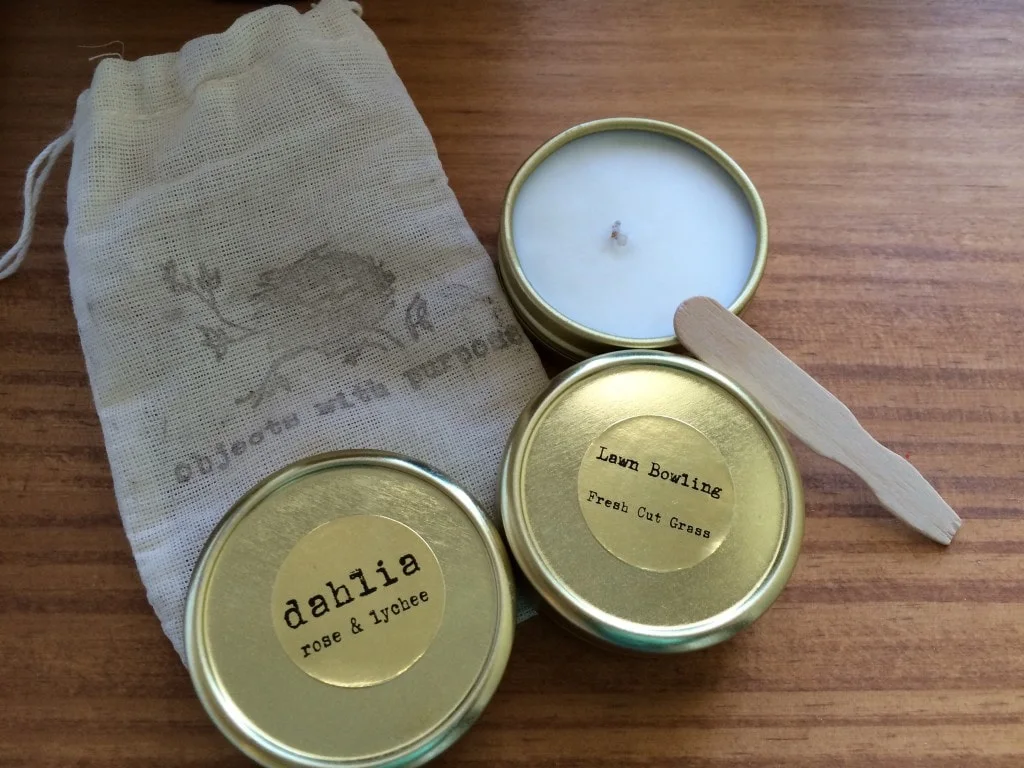 three tins with candle wax against burlap bag