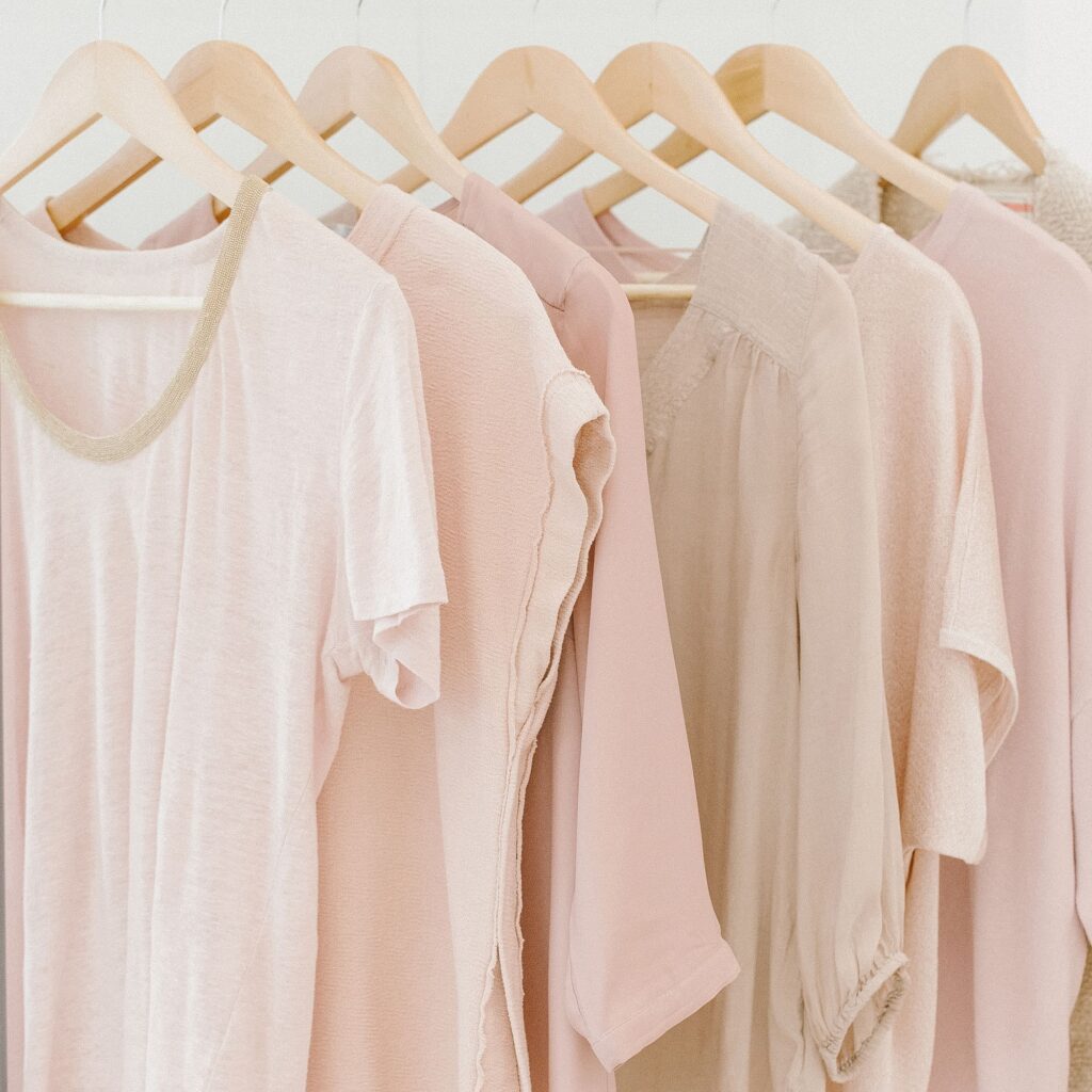 pink t-shirts hanging on a clothing rack