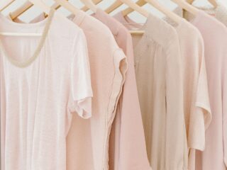 pink t-shirts hanging on a clothing rack