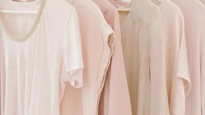 pink t-shirts hanging on a clothing rack