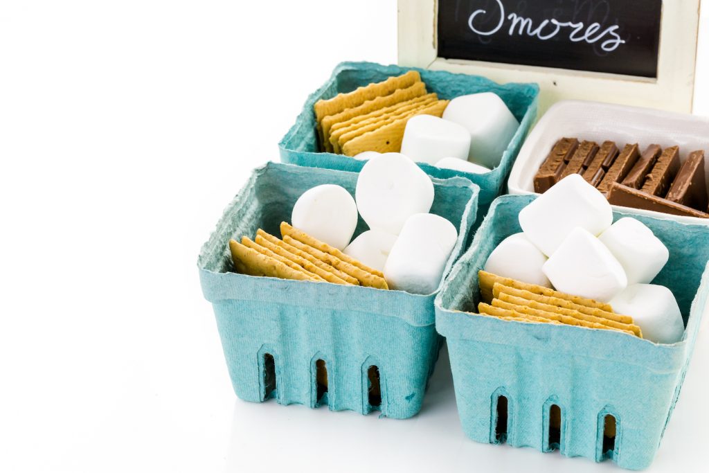 smores kit ingredients in baskets of marshmallows graham crackers and chocolate