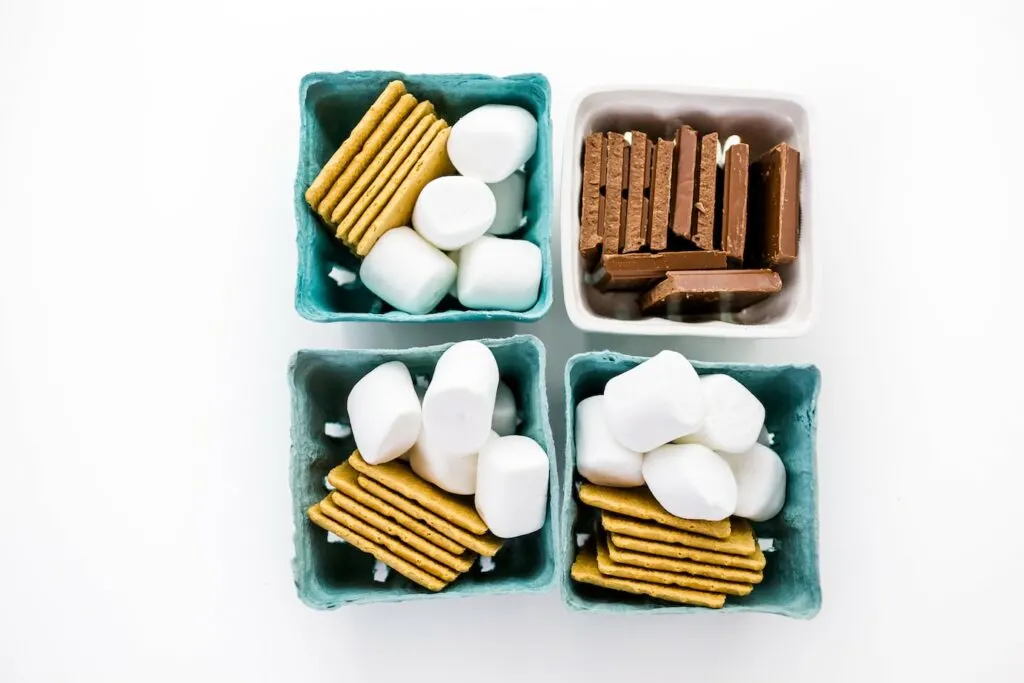 blue baskets filled with smores kit ingredients marshmallows graham crackers and chocolate