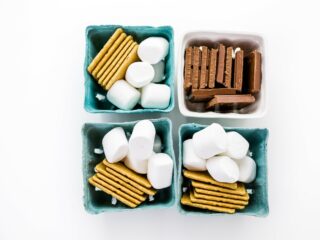 blue baskets filled with smores kit ingredients marshmallows graham crackers and chocolate