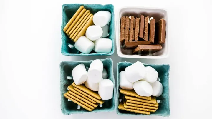 blue baskets filled with smores kit ingredients marshmallows graham crackers and chocolate
