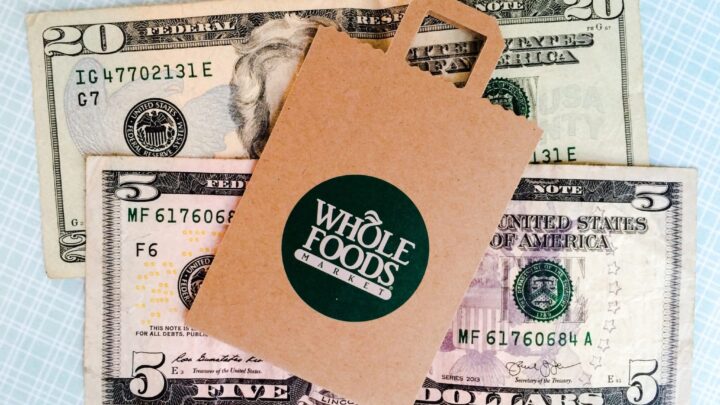 Whole Foods bag lying on top of money