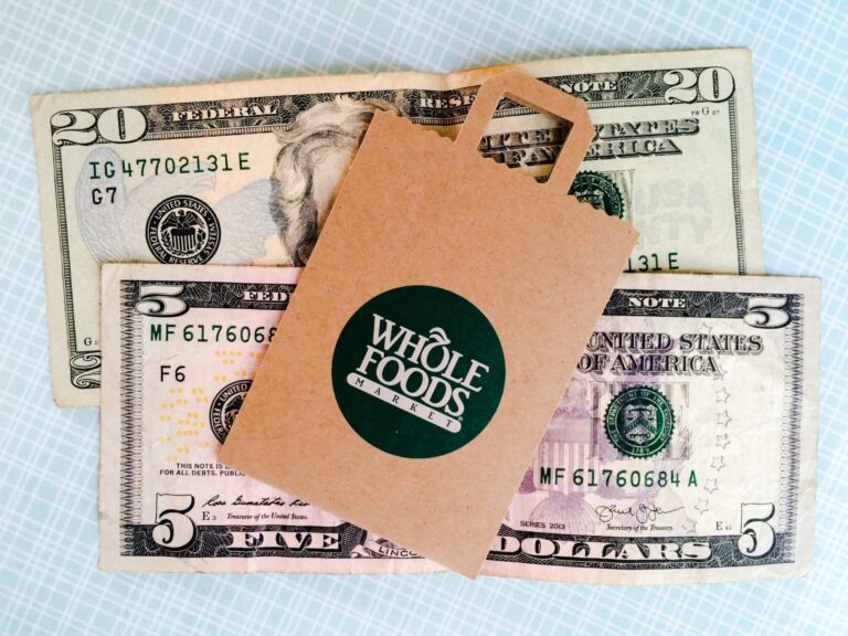 Whole Foods bag lying on top of money