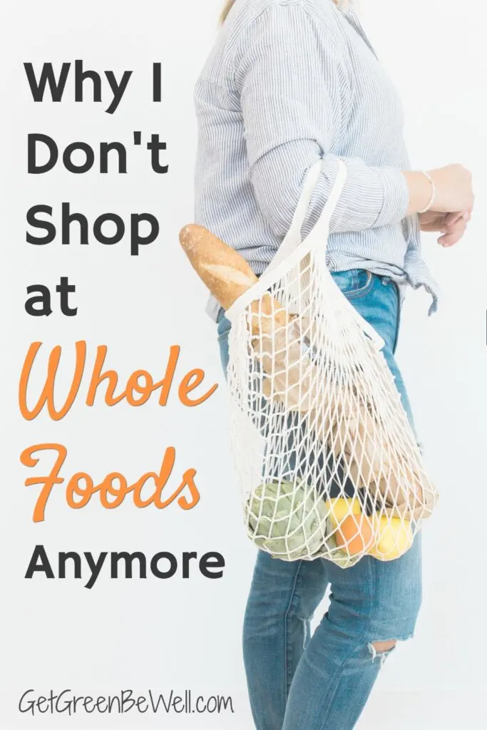 woman holding mesh grocery bag full of produce and bread