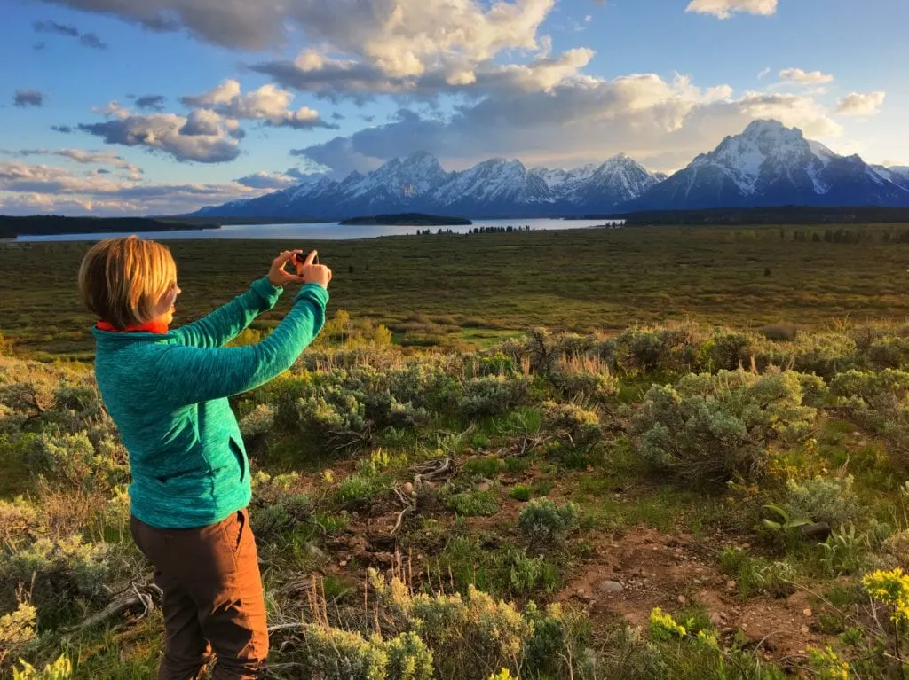 Kim photographing the Grand Tetons with iPhone