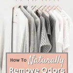 white and grey clothes hanging on copper hangers in closet against white wall