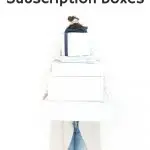 woman holding white boxes in front of her