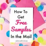 White piece of paper and pink envelope with tissue confetti against pink background
