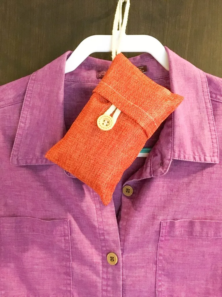 bamboo deodorizer hanging on hanger with purple shirt