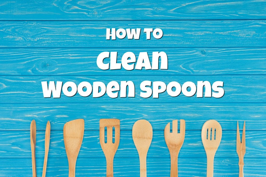 blue wooden background with wooden spoons and wood spatulas