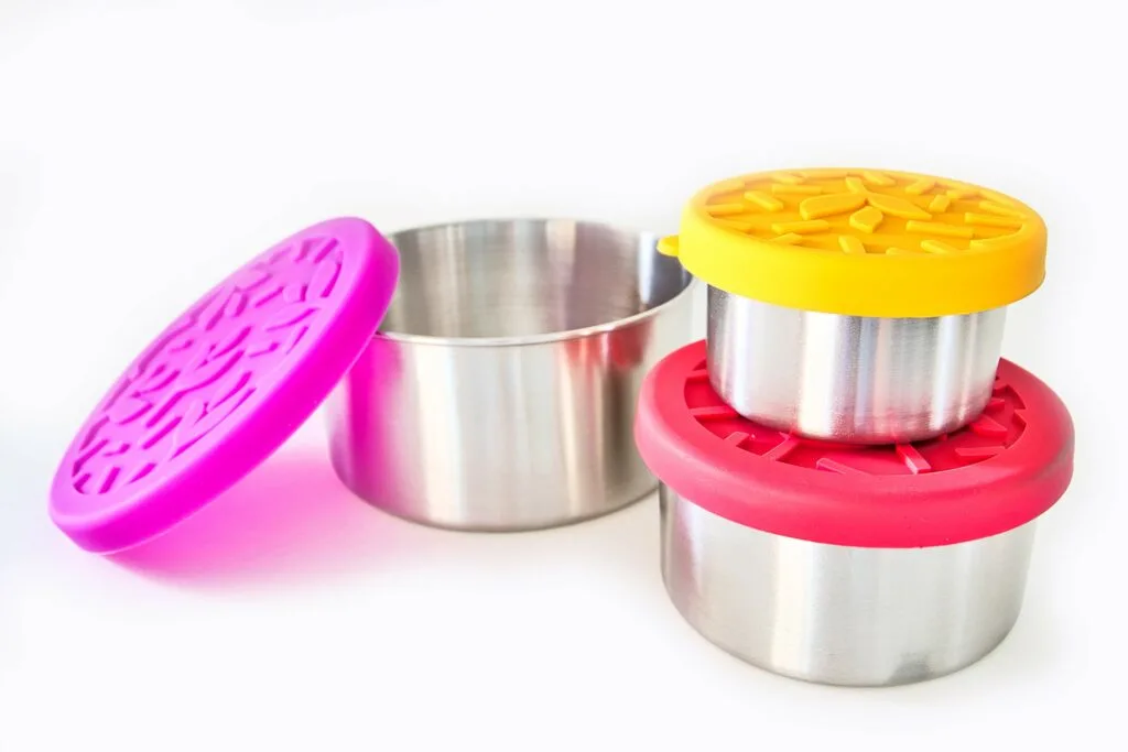 three stainless steel bowls with brightly colored silicone lids