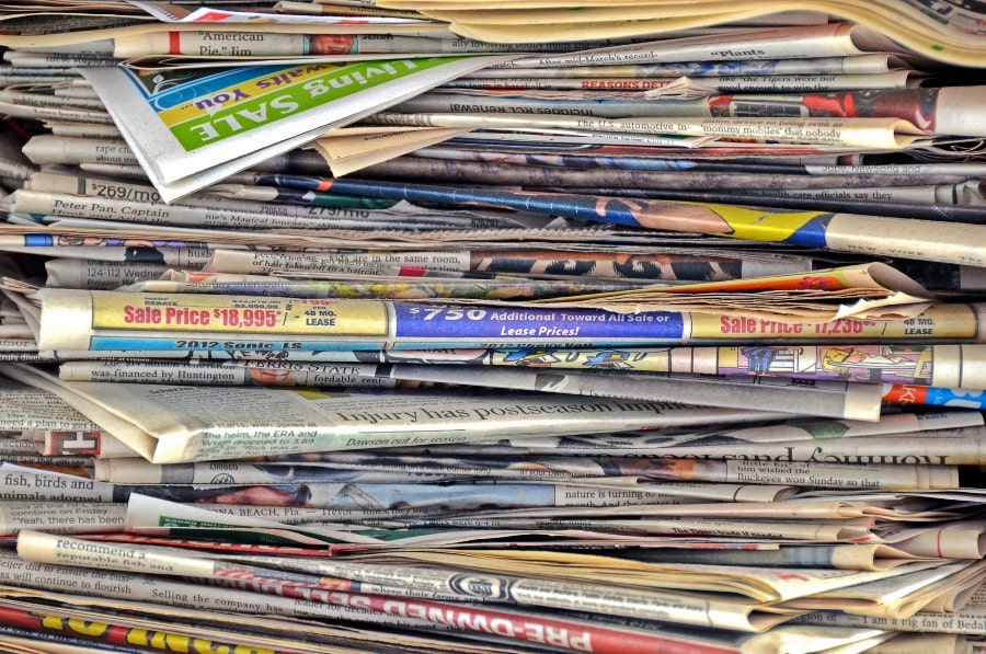 stack of newspapers to be used as mulch in the garden