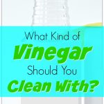 clear glass bottle of vinegar on white background