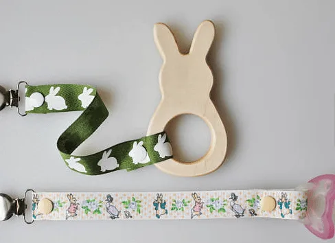 wood bunny baby teether with easter ribbon attached to pacifier