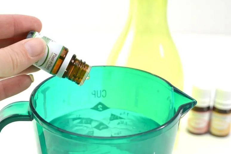 Drops of essential oil added to homemade vinegar cleaner