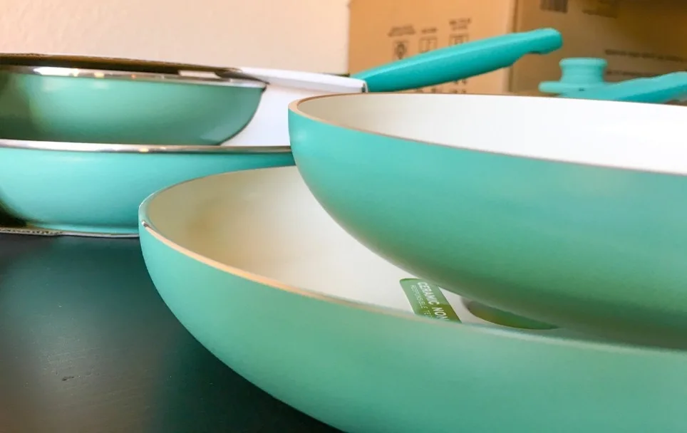 turquoise nonstick pans with white ceramic interior coatings