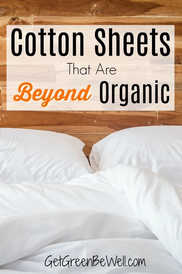 organic cotton sheets on bed with two pillows against wooden headboard