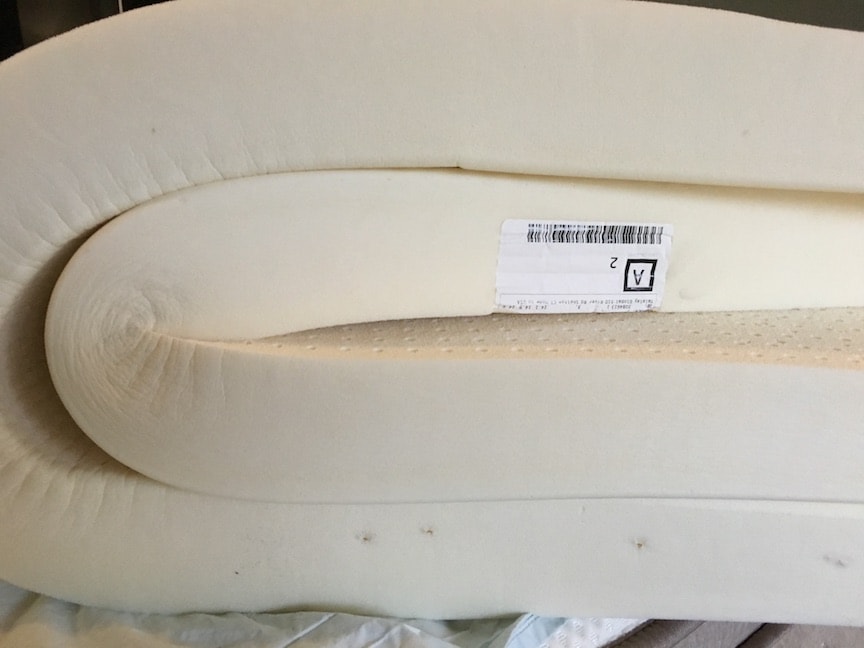 latex for less mattress topper folded up on bed