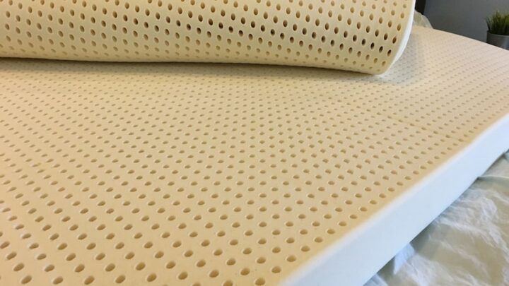 Latex for Less Mattress Topper unrolled on a bed
