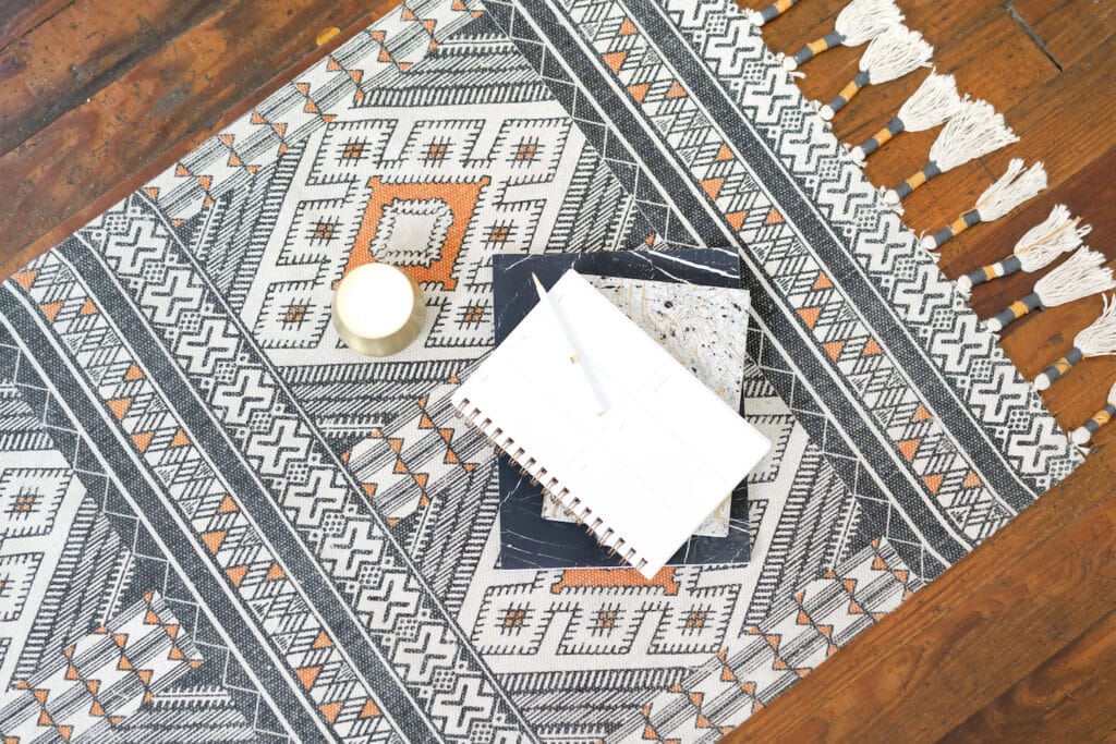 area rug with tassels on wooden floor