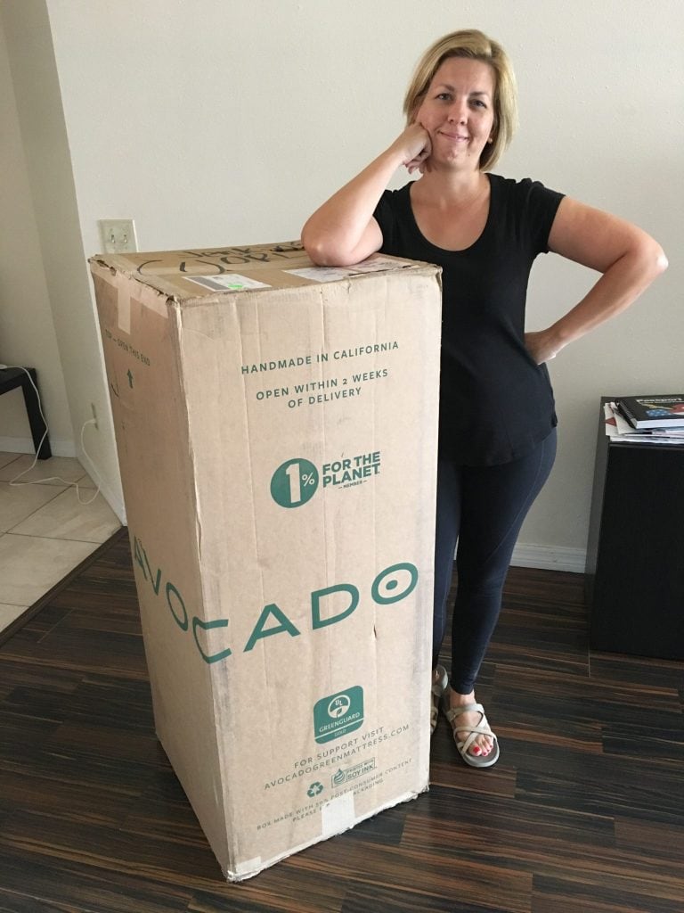 Bed in a box with woman standing beside