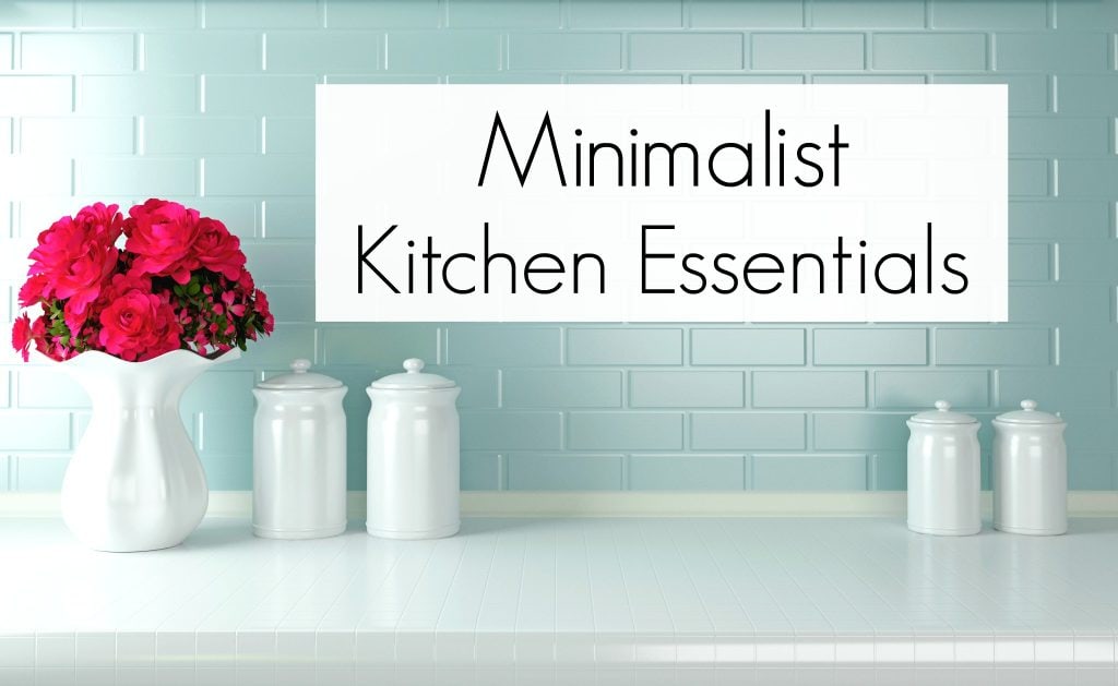 Minimalist Kitchen blue brick backsplash with white counter tops and white vase of pink flowers