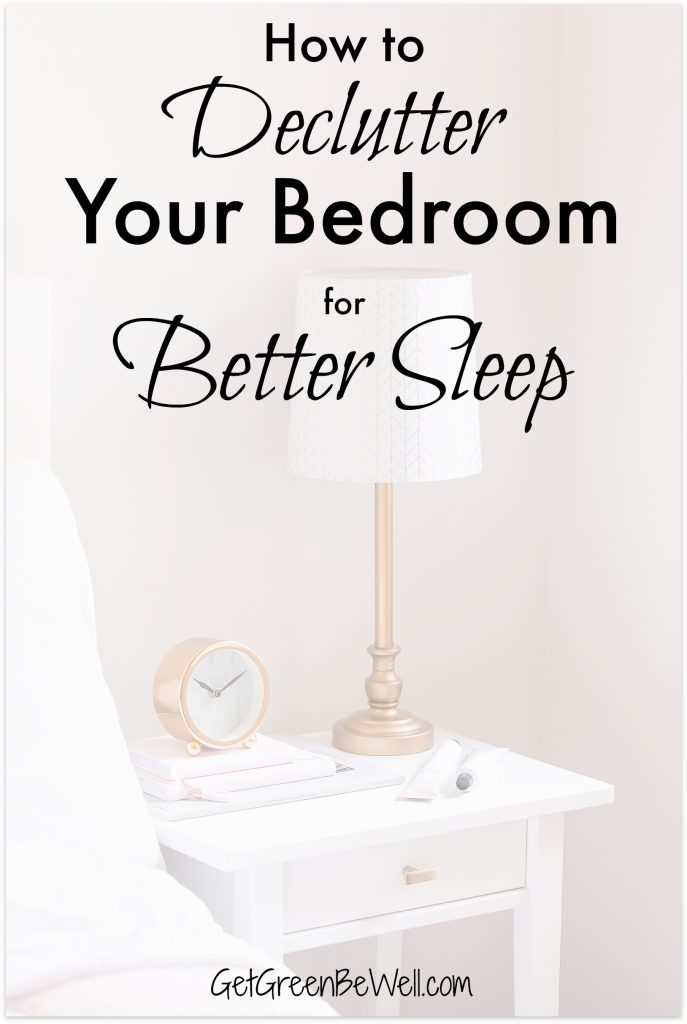 Bedside lamp on night table in bedroom with clock and books on top