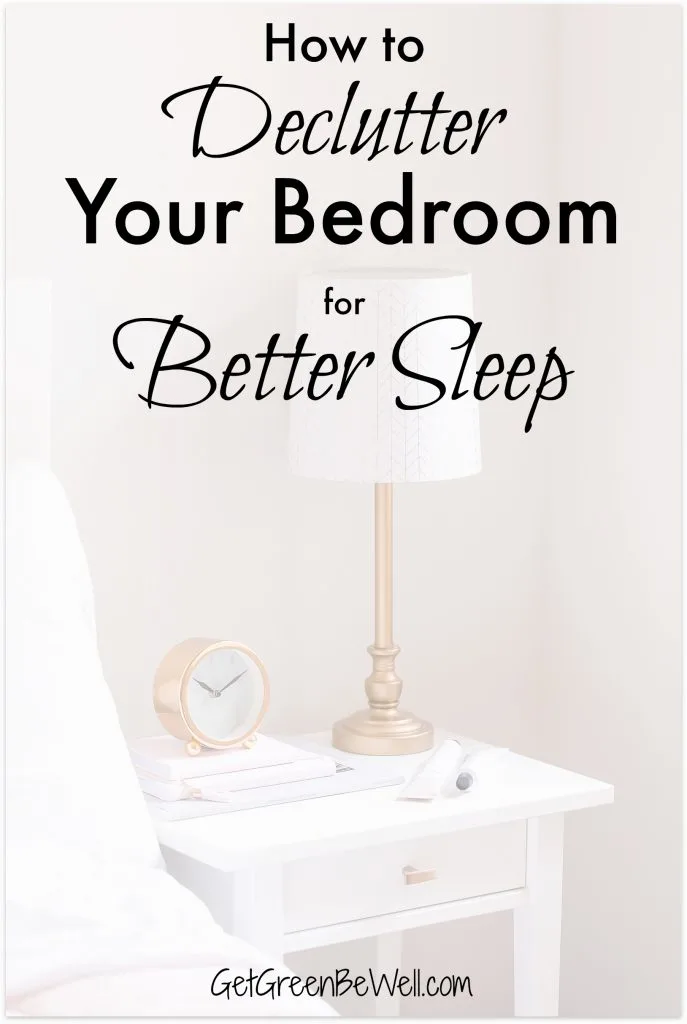 Bedside lamp on night table in bedroom with clock and books on top