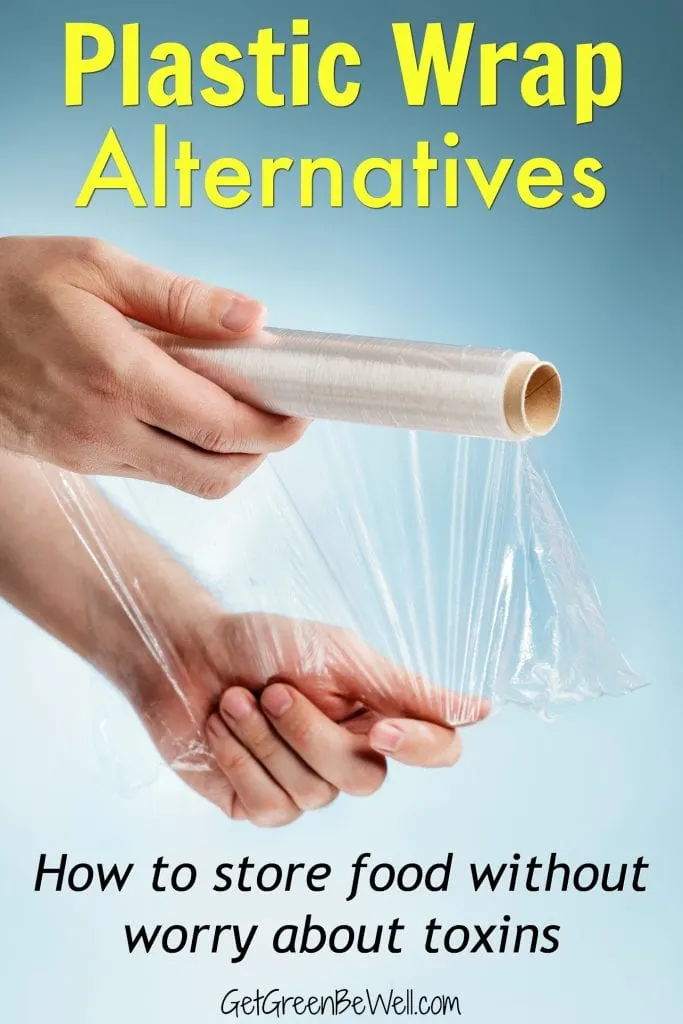 Man holding a roll of plastic film, typically used for sealing food items.