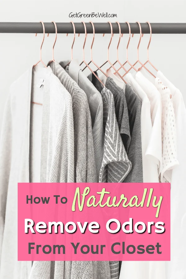 white and grey clothes hanging on copper hangers in closet against white wall