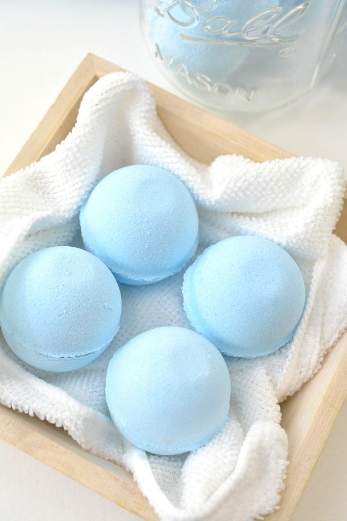 blue round toilet bowl cleaner tablets in a wooden box