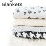 stack of warm fuzzy weighted blankets in grey, white and cream colors