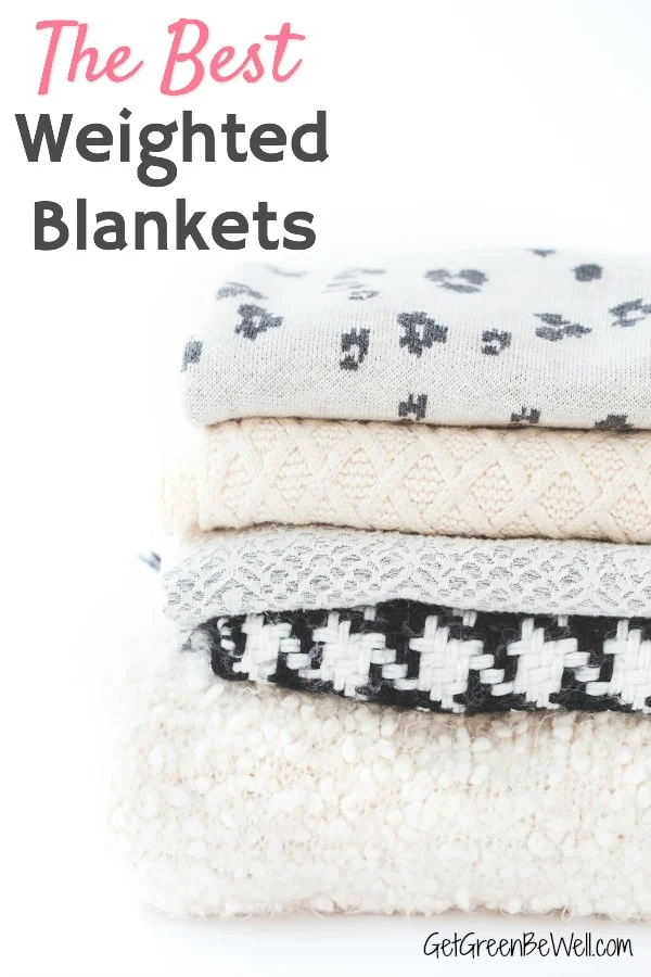 stack of warm fuzzy weighted blankets in grey, white and cream colors 