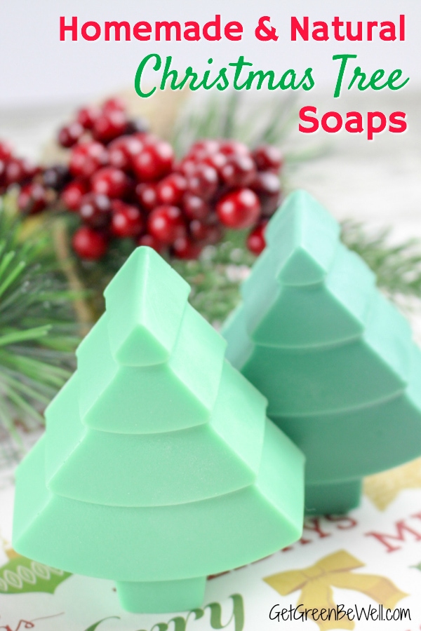 three christmas tree soaps in different shades of green next to pine needles and holly berries