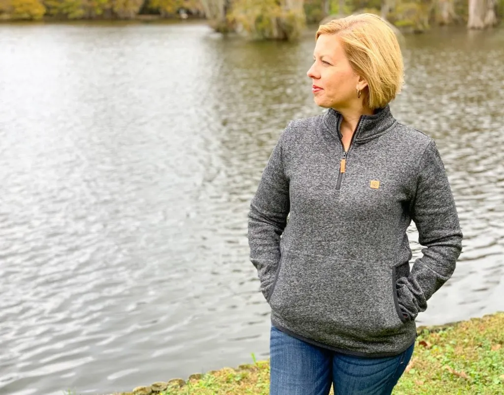 woman looking across lake wearingtentree opal zip hoodie sustainable fashion