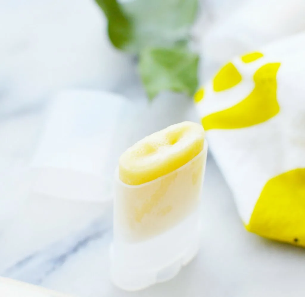 Winter skin balm in a plastic tube on marble table