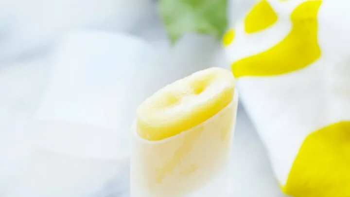 Winter skin balm in a plastic tube on marble table