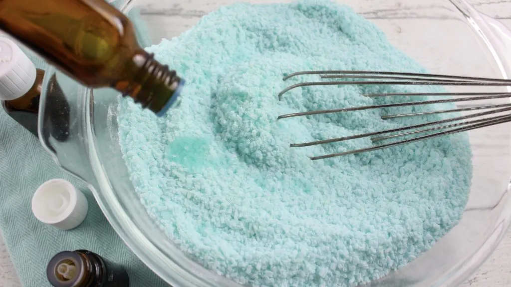 adding essential oils to sinus relief bath soak bath salts in glass bowl 