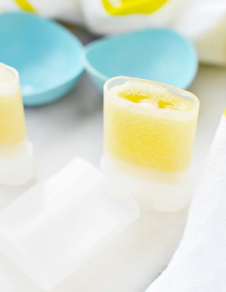 body balm poured into a tube against white marble table