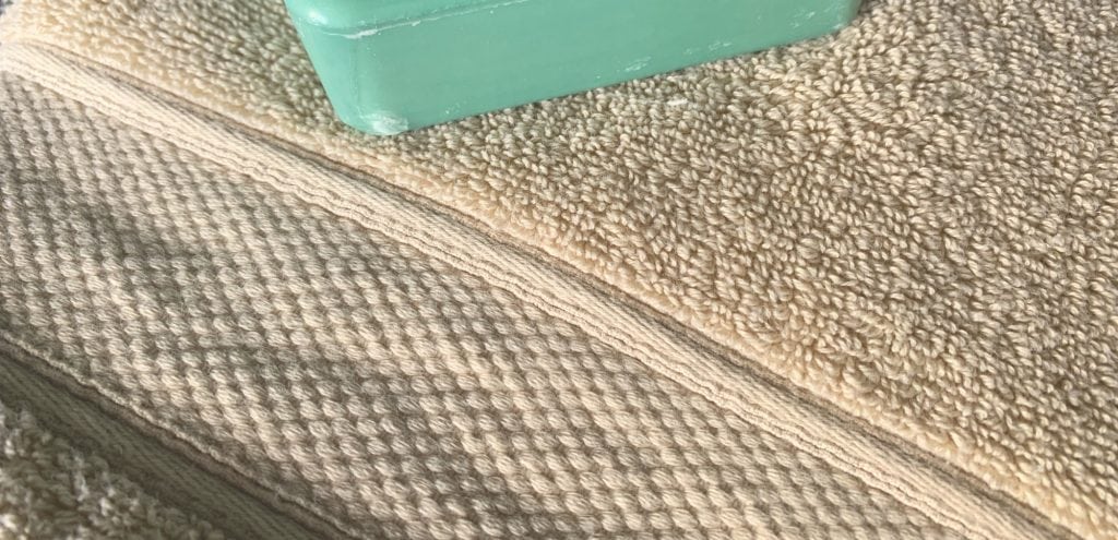 Grund America organic cotton bath towel driftwood color with green bar of soap
