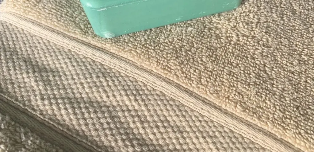 Grund America organic cotton bath towel driftwood color with green bar of soap