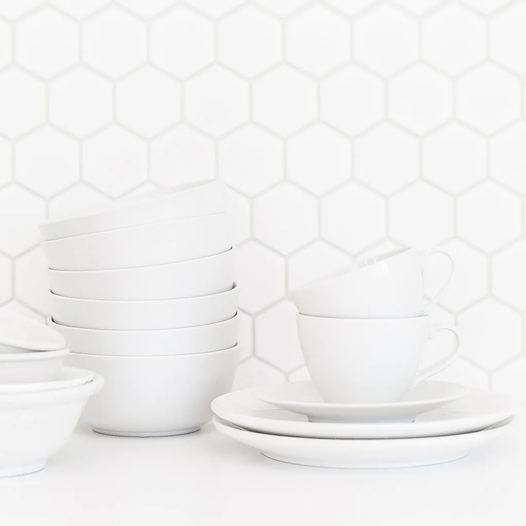 minimalism white dishes mugs bowls against white backsplash uncluttered