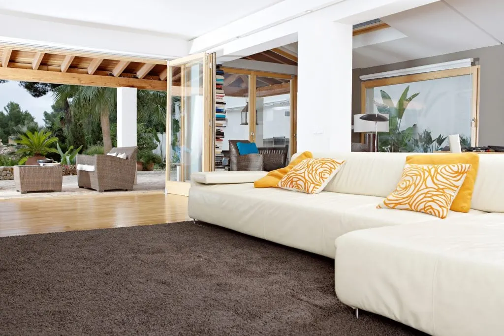 open living room with foldable walls leading to outdoors with bright light fresh air wellness architecture
