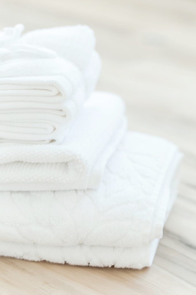 white towels stacked against wood background